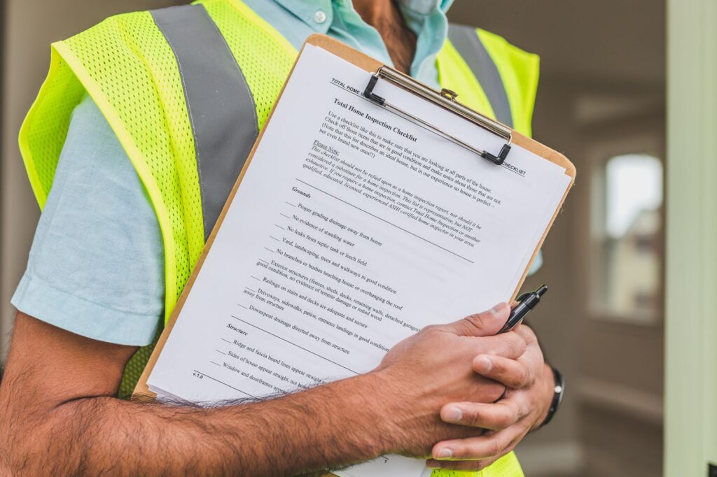 General contractor reviewing an invoice and payment schedule at a construction site