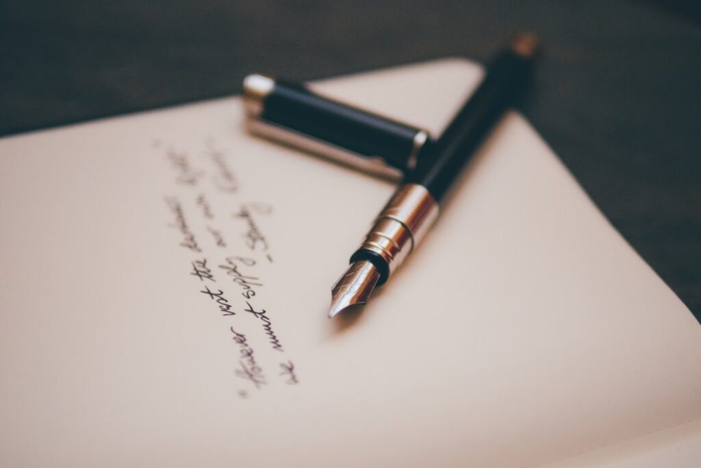 Close-up of merchant cash advance contract fine print with a pen