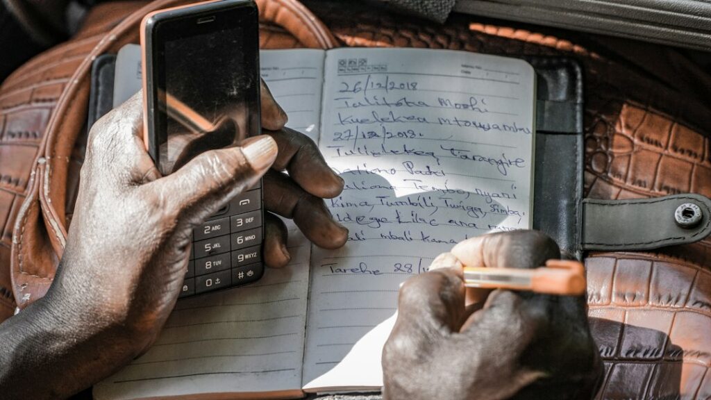 Business owner calculating financing costs using receipts and a calculator