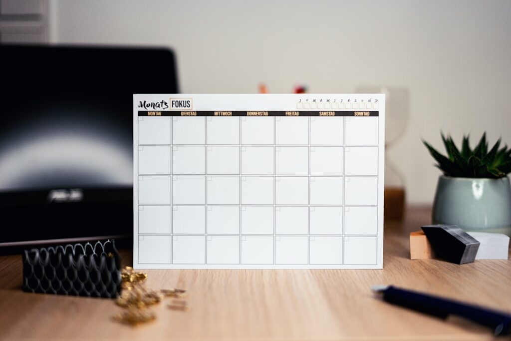 Calendar and calculator on a desk representing seasonal cash flow planning