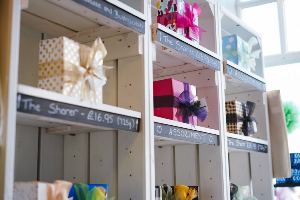 Small business owner unpacking seasonal retail inventory boxes in a storefront