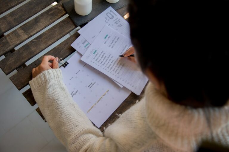Small business owner reviewing financial paperwork at a desk