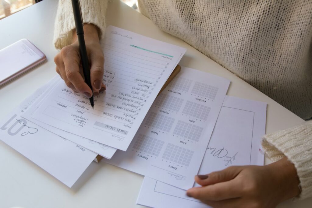 Multiple stacks of funder contracts spread across a desk representing stacked MCA advances