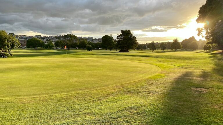 Golf course fairway in low autumn light with no golfers on the course