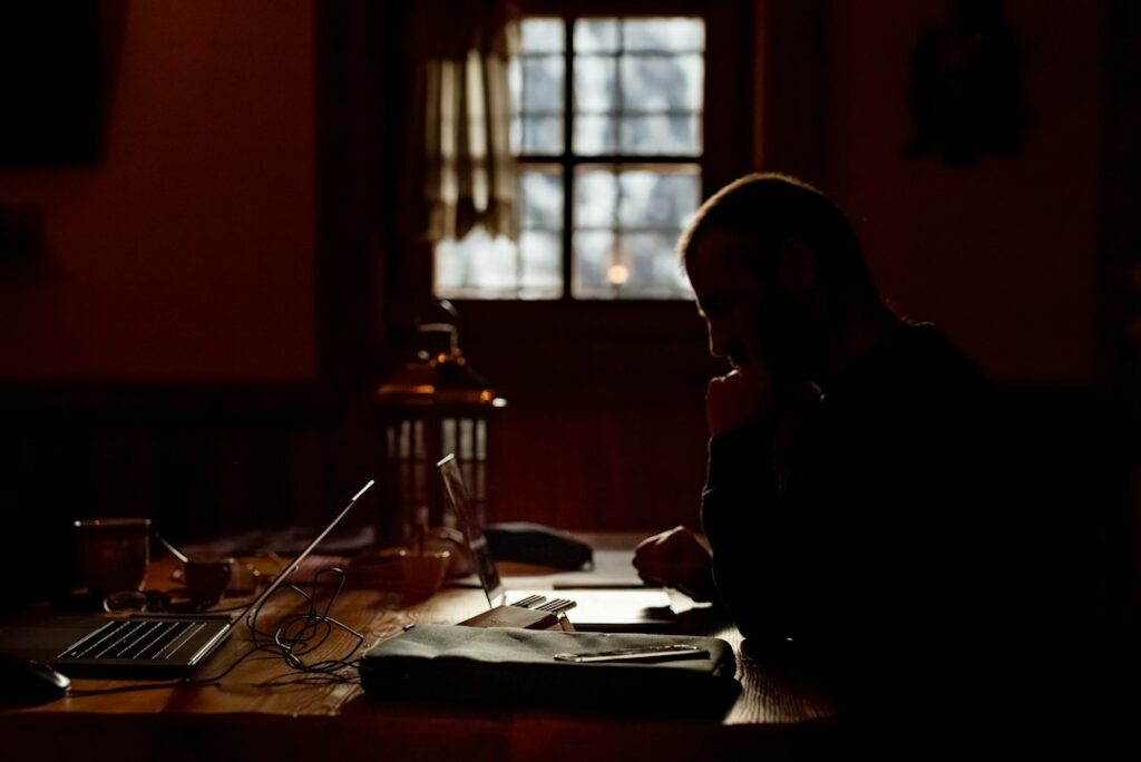 Farm business owner reviewing bills and financing paperwork at a desk