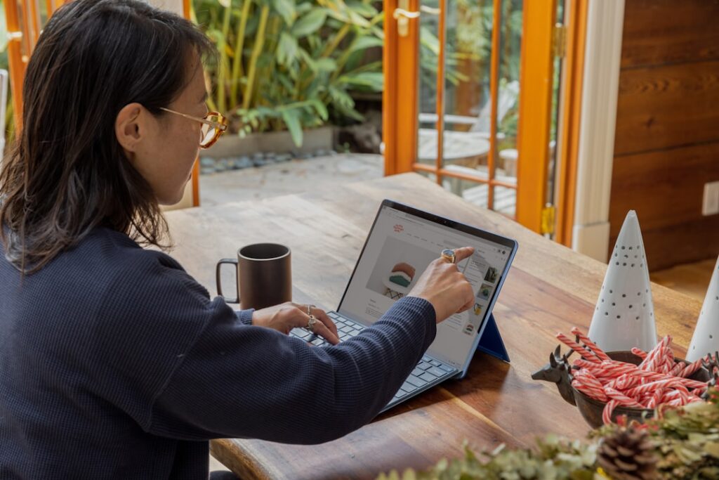 Small business owner reviewing purchase orders and a calendar to plan holiday inventory