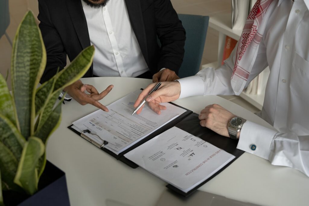 Business attorney reviewing contract documents with a small business owner