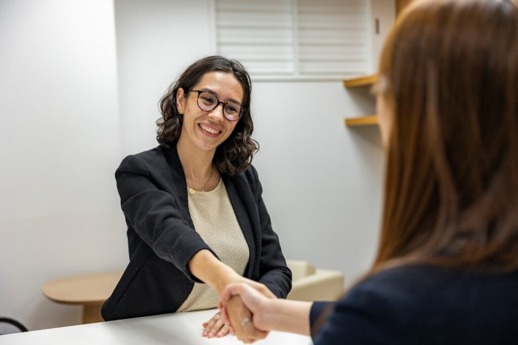 Business owner shaking hands after a successful negotiation meeting