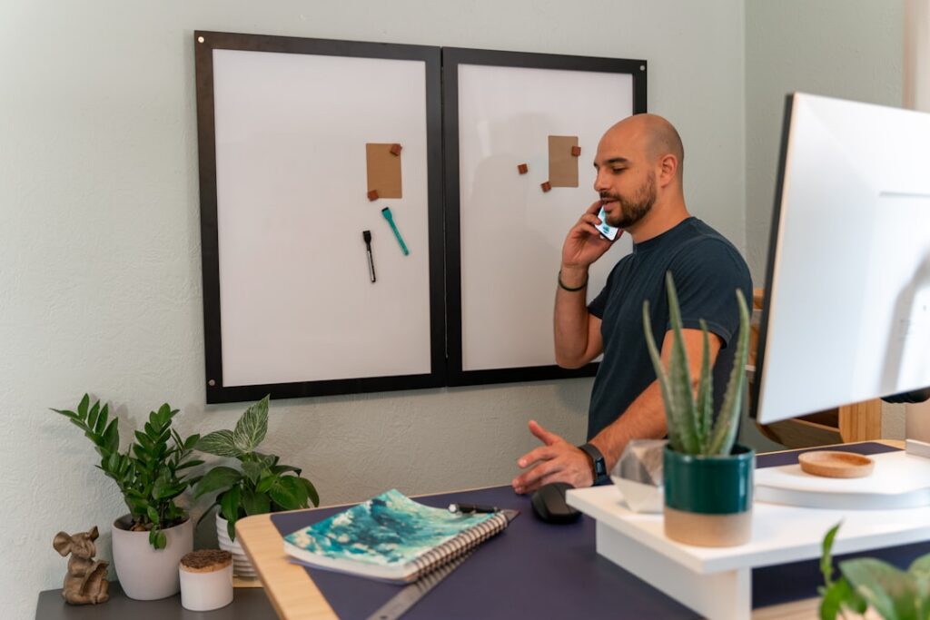 Small business owner having a confident phone conversation in a bright office