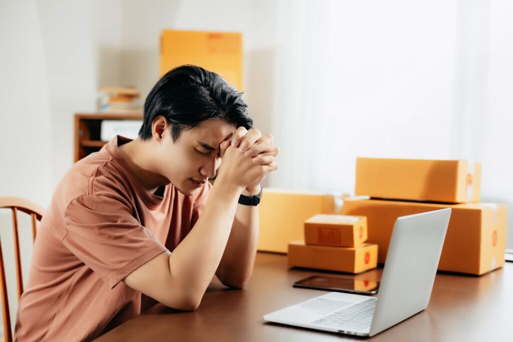 Business owner checking bank account balance on a laptop early in the morning