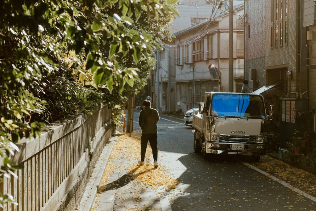 Landscaping business owner reviewing finances on a clipboard beside a work truck