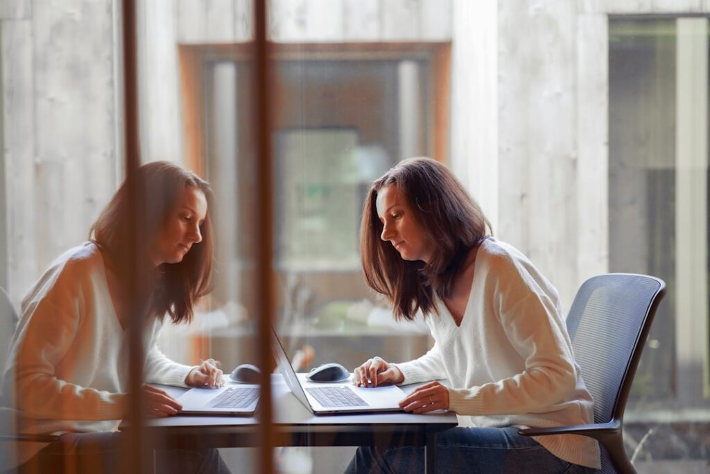Two business professionals negotiating over settlement contract documents at a desk