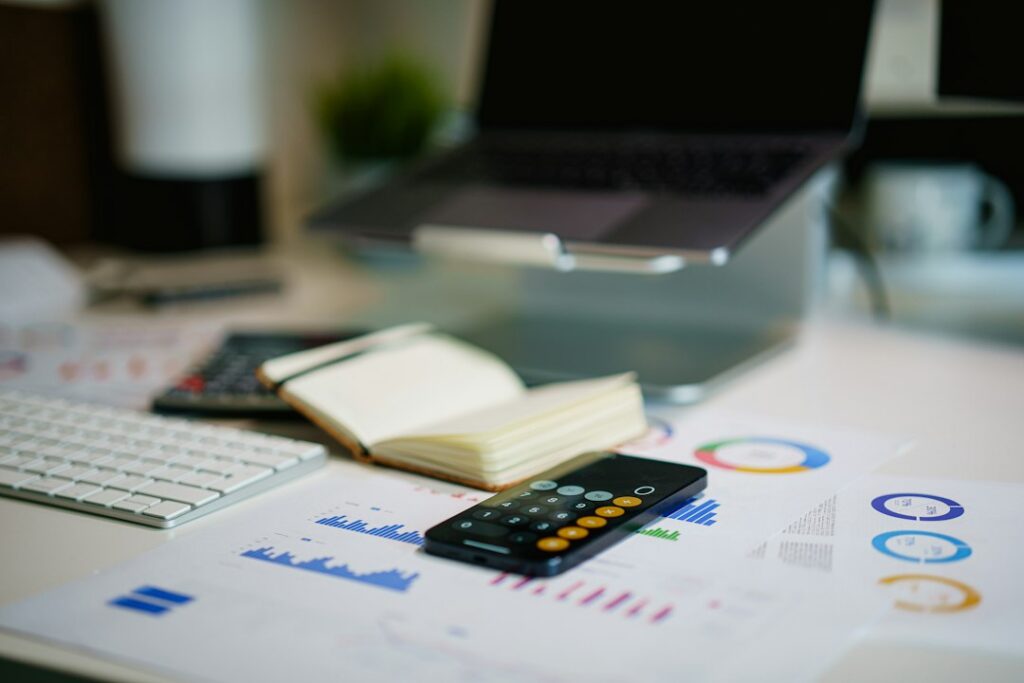 Calculator and financial documents used to compare loan offers
