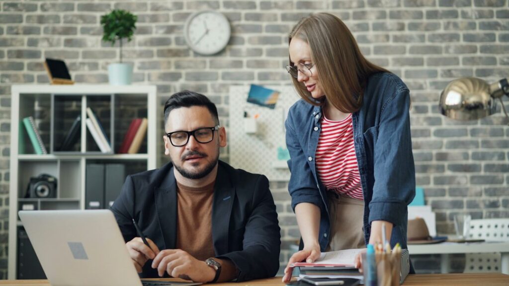 Business owner and advisor negotiating debt terms across a desk