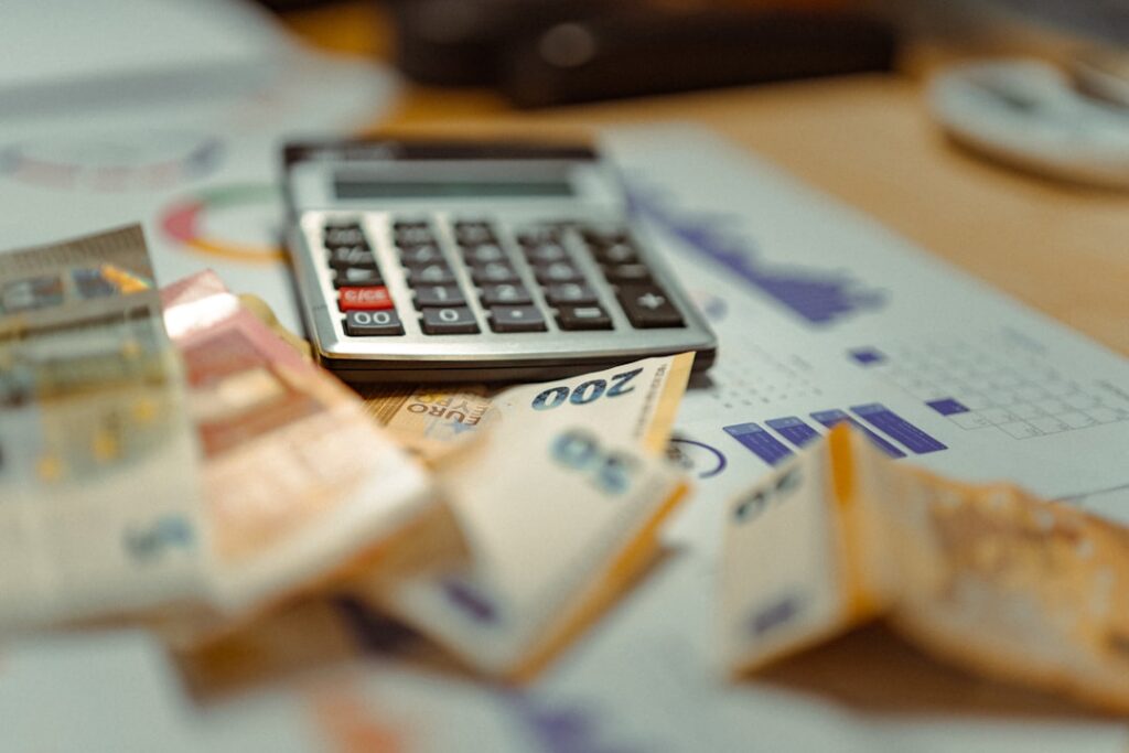 Calculator, bank statements, and car keys on a dealership desk