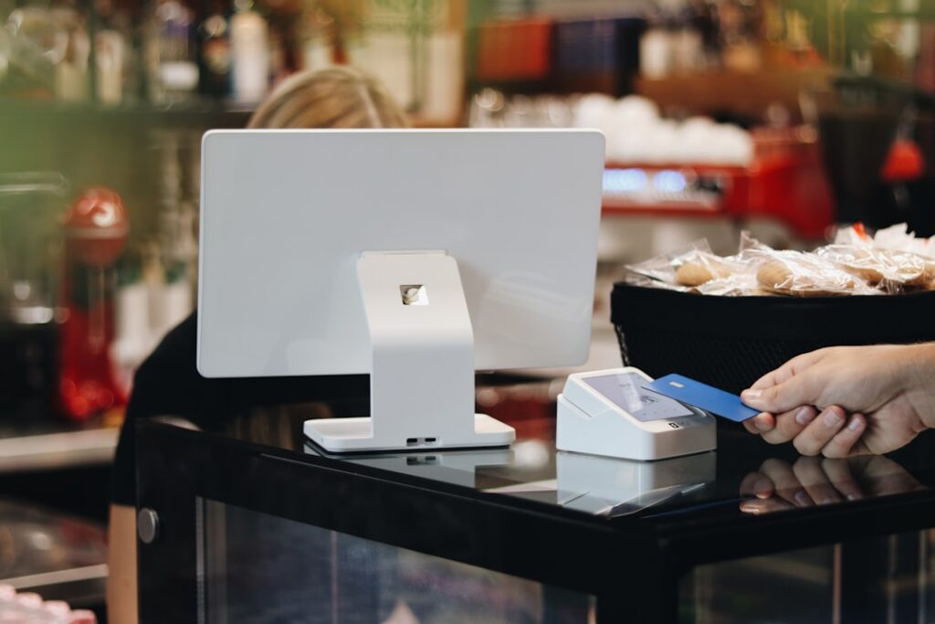 Calculator and stack of invoices on a small retail shop counter