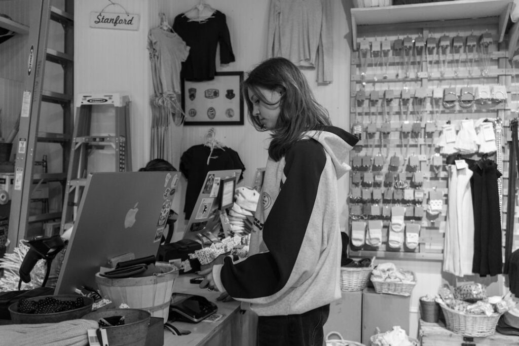 Boutique retail owner counting the cash register drawer at closing time