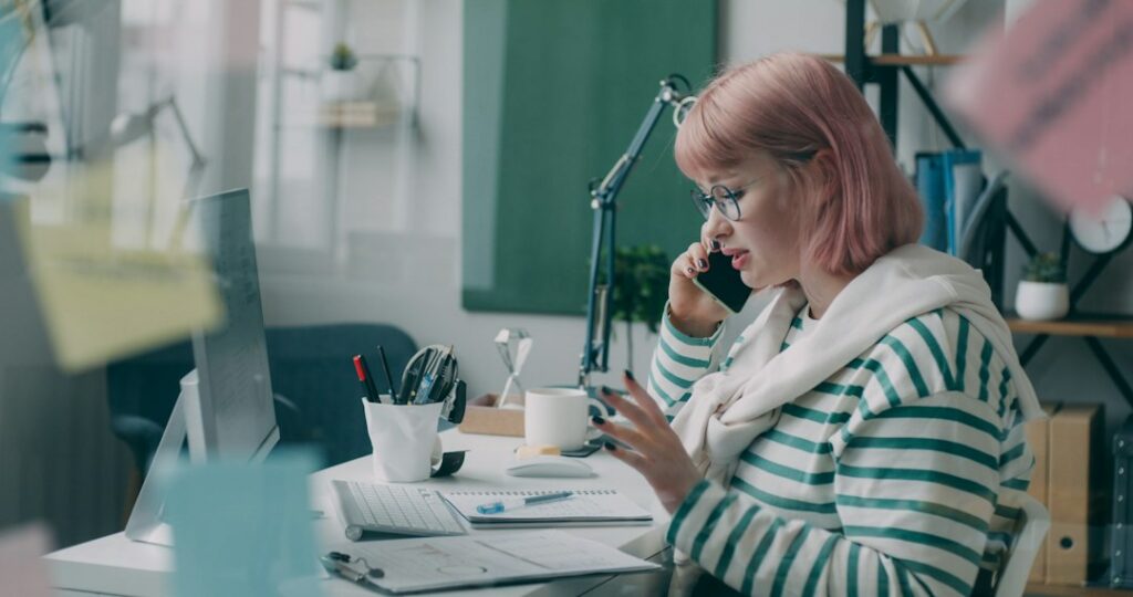 Small business owner checking bank account balance and payment notifications on a phone