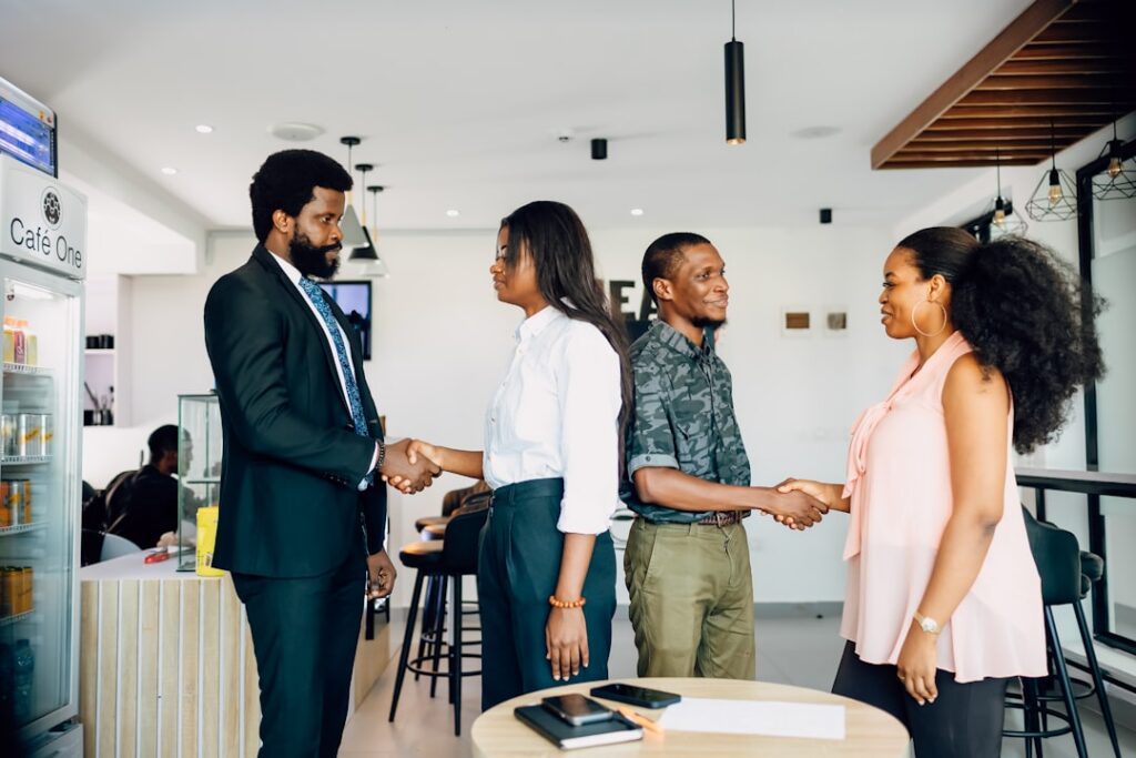 Confident small business owner shaking hands with a financial advisor in an office