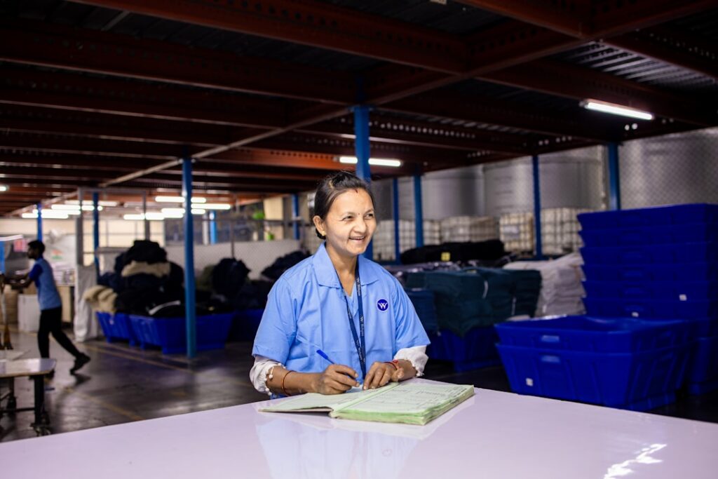 Owner reviewing paperwork on the floor of a small manufacturing shop