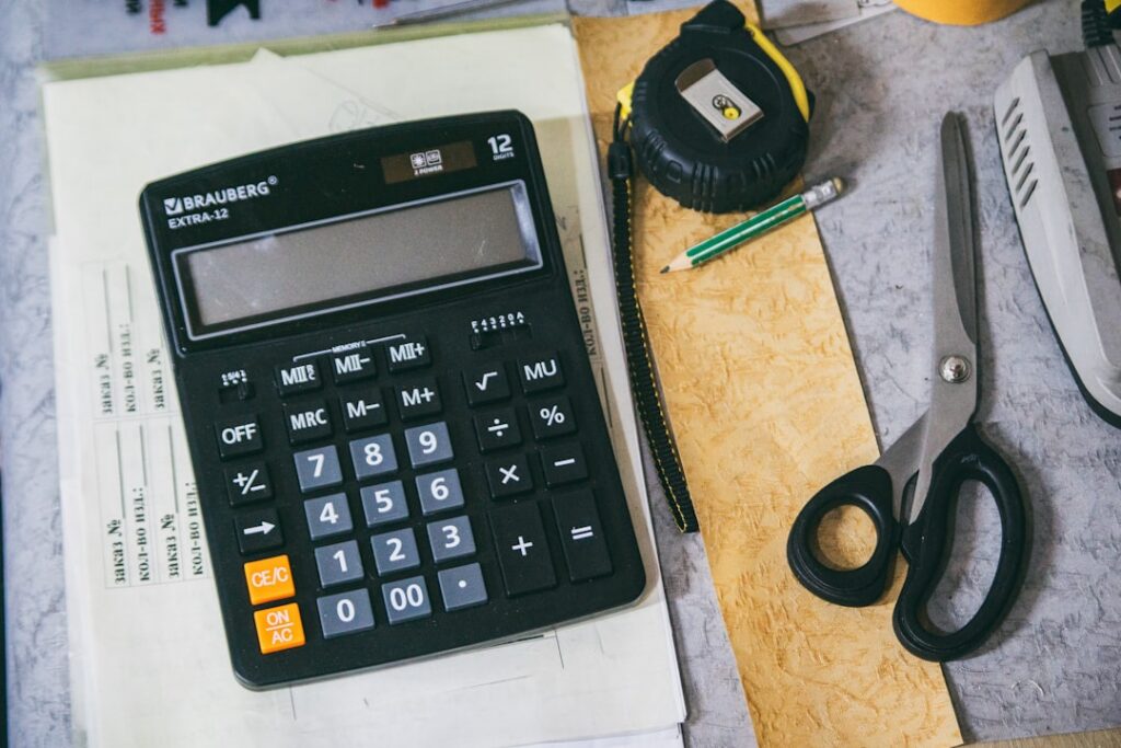 Small business owner reviewing tax refund paperwork and merchant cash advance statements at a desk