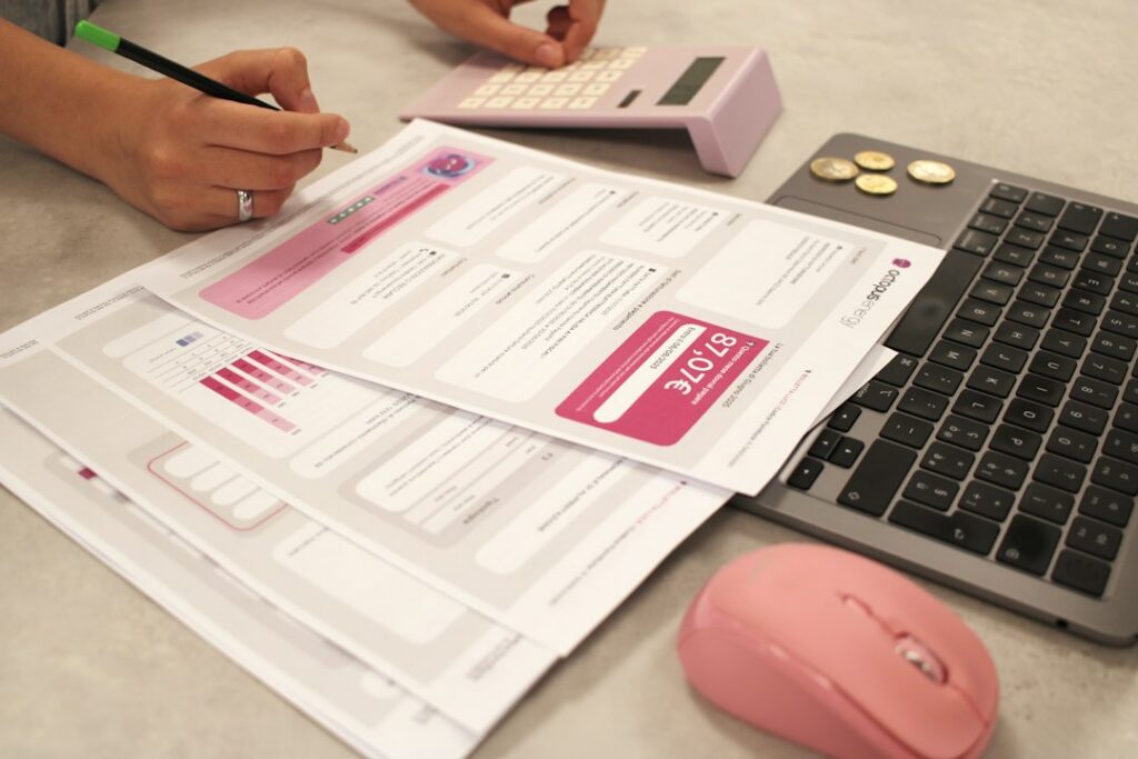 Accountant reviewing payroll tax deposit forms alongside a calculator