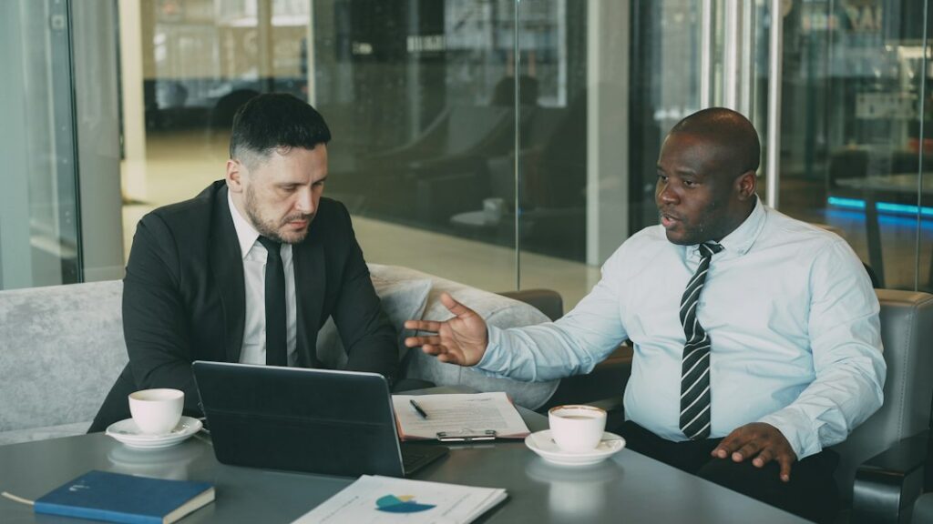 Business owner and advisor shaking hands after reaching a settlement agreement
