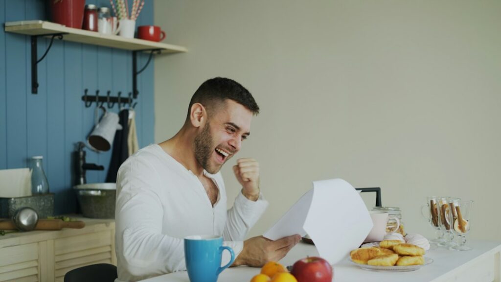 Small business owner reviewing federal loan paperwork at a table