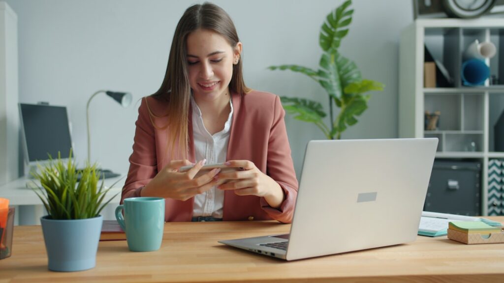Business owner reviewing invoices and running numbers on a calculator at a desk