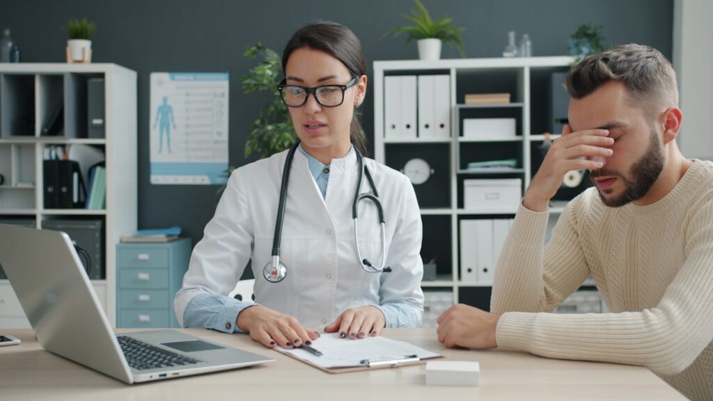 Chiropractic practice owner reviewing insurance claim paperwork at a clinic desk