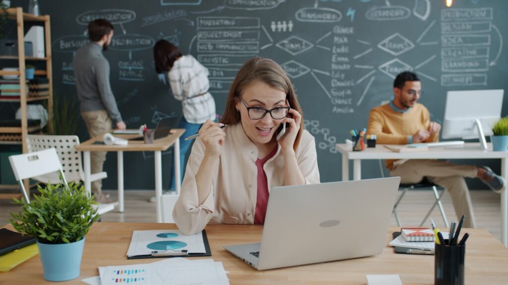Confident business owner on a phone call in a small office