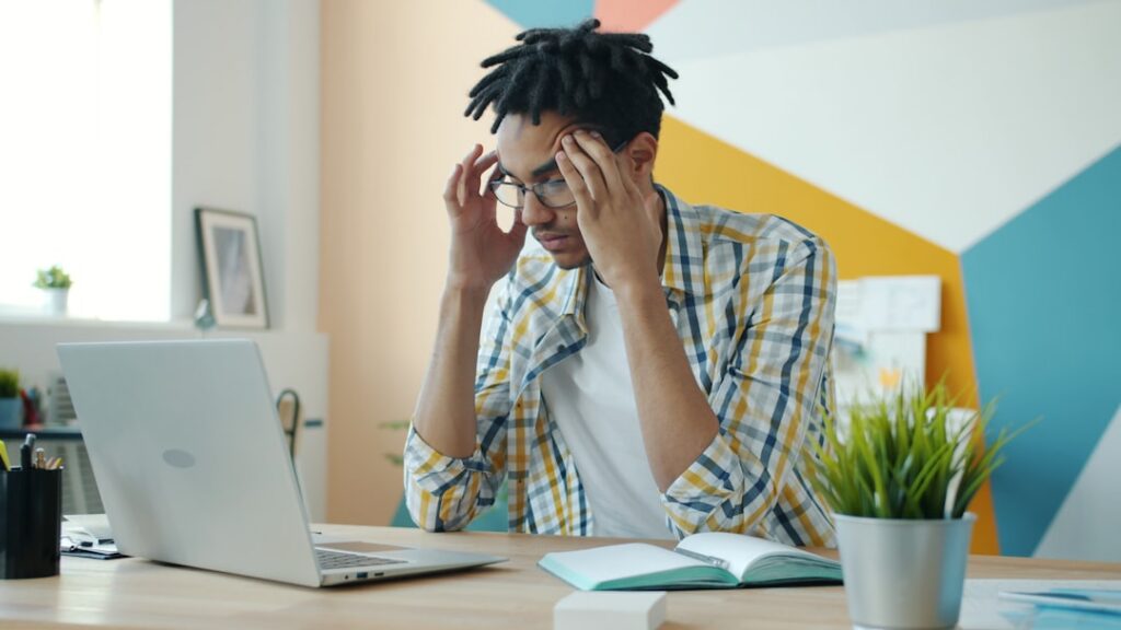 Small business owner looking over financial paperwork with a concerned expression