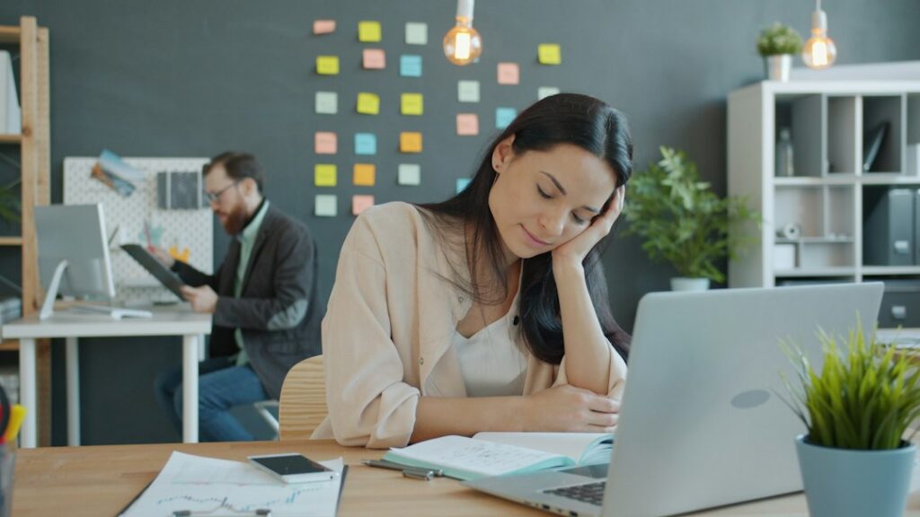 Small business owner reviewing a tax deadline calendar and bills at a desk