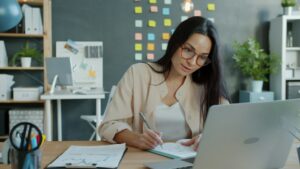 Small business owner reviewing tax documents and calculator at a desk
