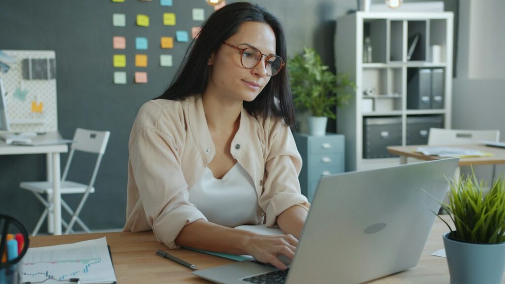Used car dealership owner reviewing financing paperwork at a desk