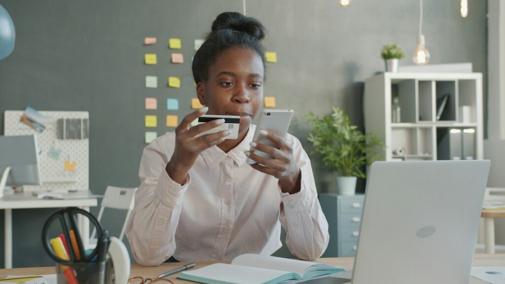 Business owner checking bank balance on a phone, watching for a bounced payment