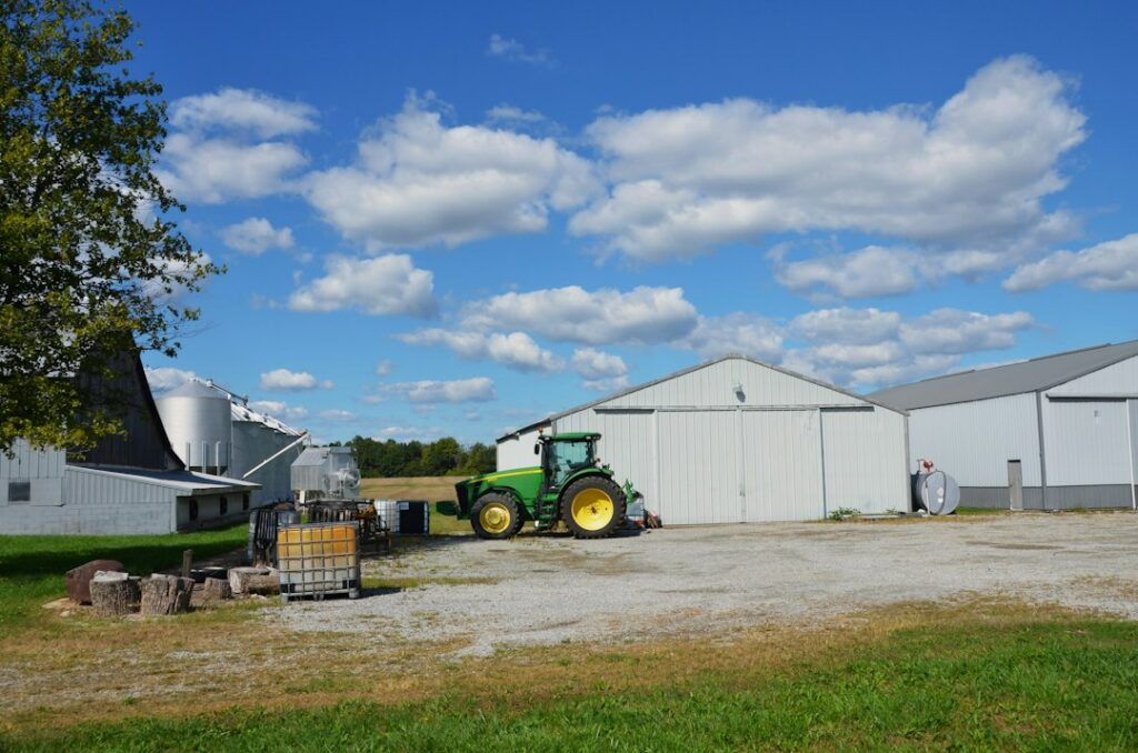 Farm equipment used for baling and netting trees stored in a barn