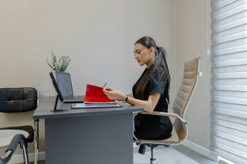 Small business owner reviewing federal loan and MCA paperwork at a desk