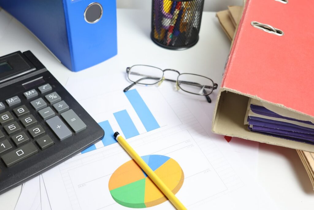 Calculator and financial statements showing a balance escalating