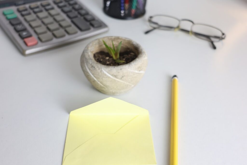 Calculator and stack of bills on a business owner's desk