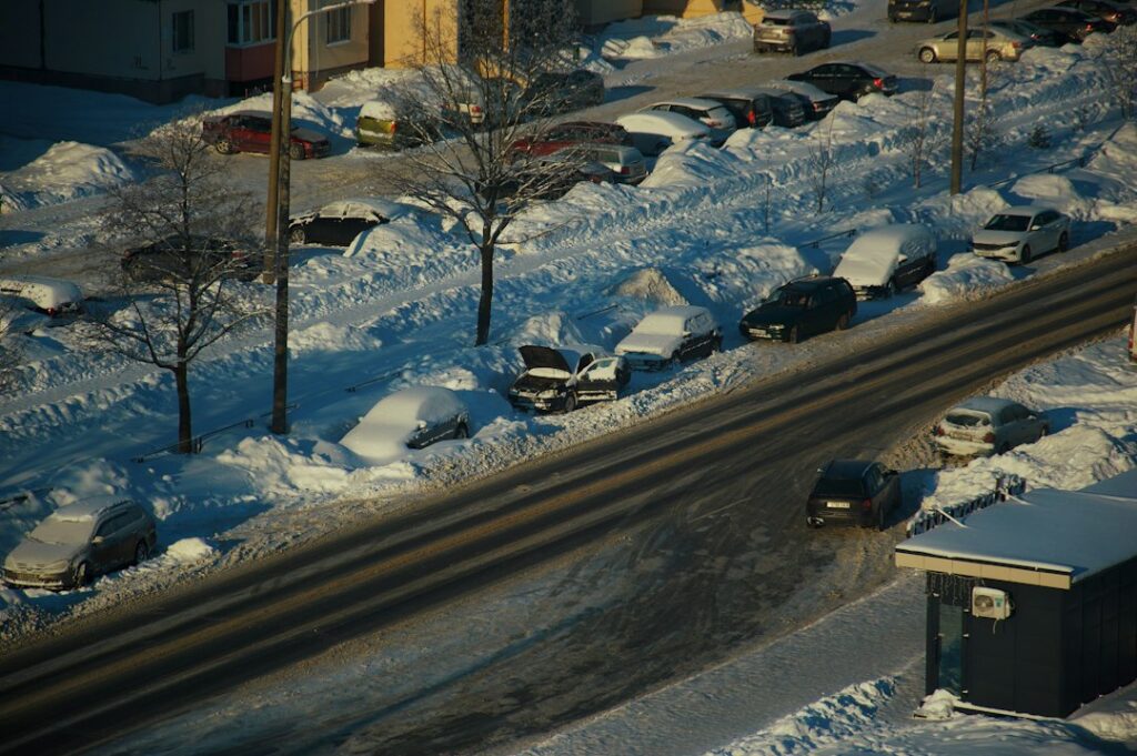 Idle snow removal trucks waiting in an empty lot before the first storm