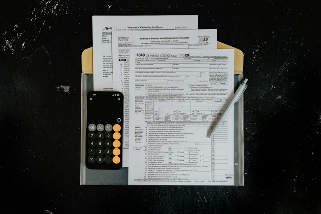 Calculator and stack of medical billing invoices on a clinic office desk