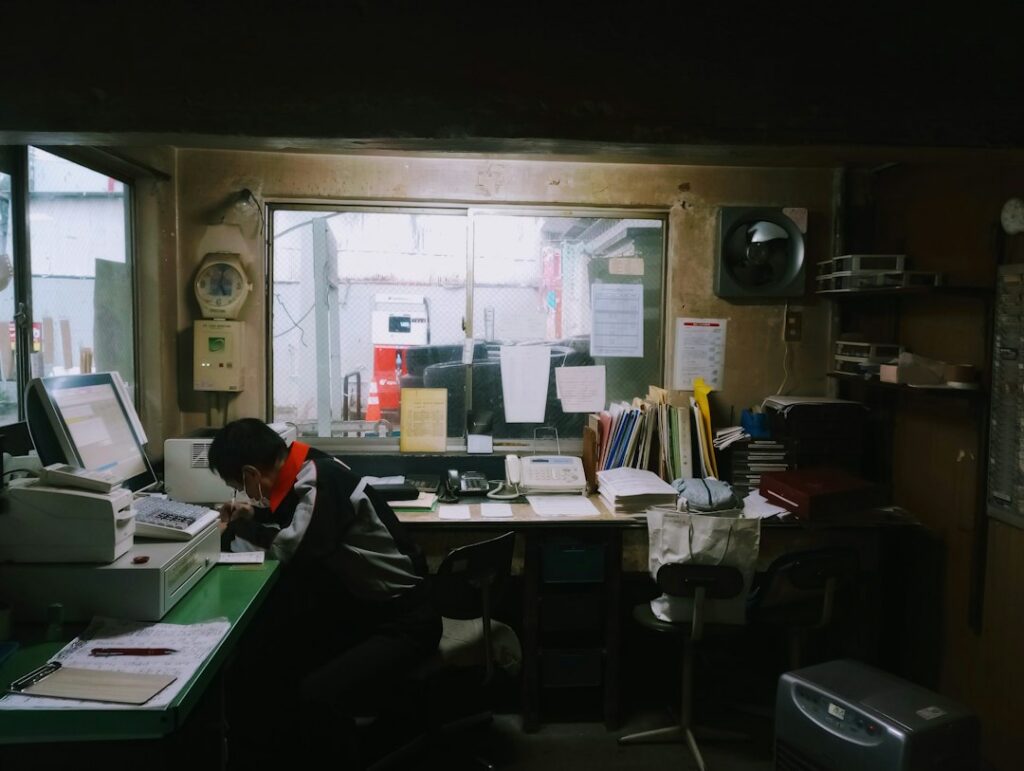 Small business owner reviewing invoices and a calendar at a desk in September