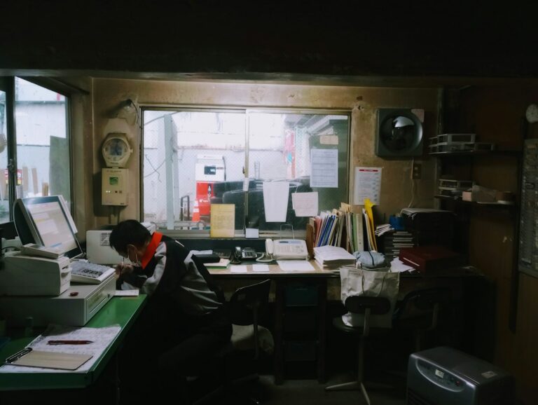 Small business owner reviewing invoices and a calendar at a desk in September