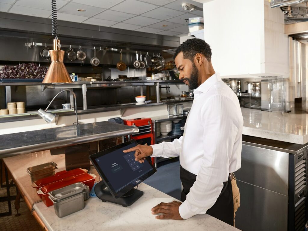 Restaurant owner checking inventory boxes in a commercial kitchen