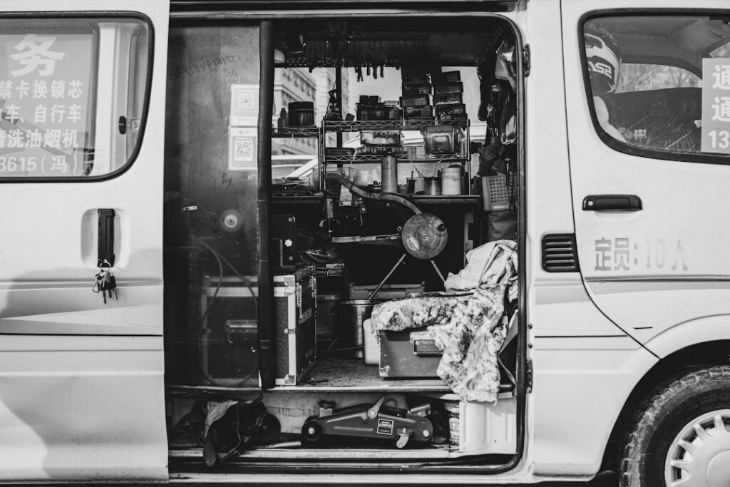 Electrician's work van loaded with wire spools, conduit, and tools