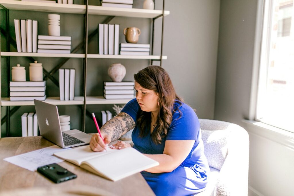 Business owner drafting a hardship request letter at a desk with contract paperwork