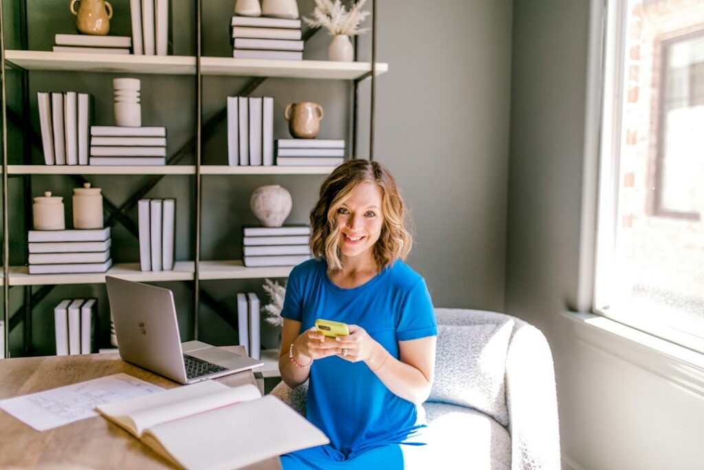 Small business owner comparing financing documents and a calculator at a desk