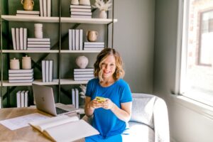 Small business owner comparing financing documents and a calculator at a desk