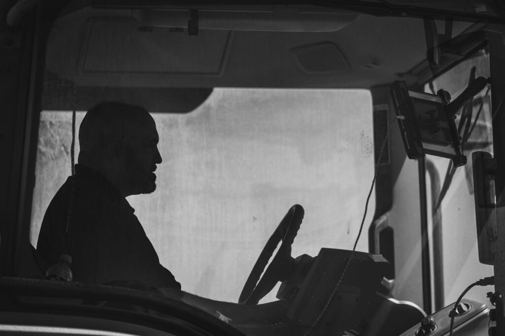 Business owner looking at a bank statement in a truck cab